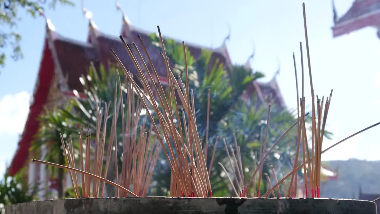 Thai incense sticks on the background of a temple