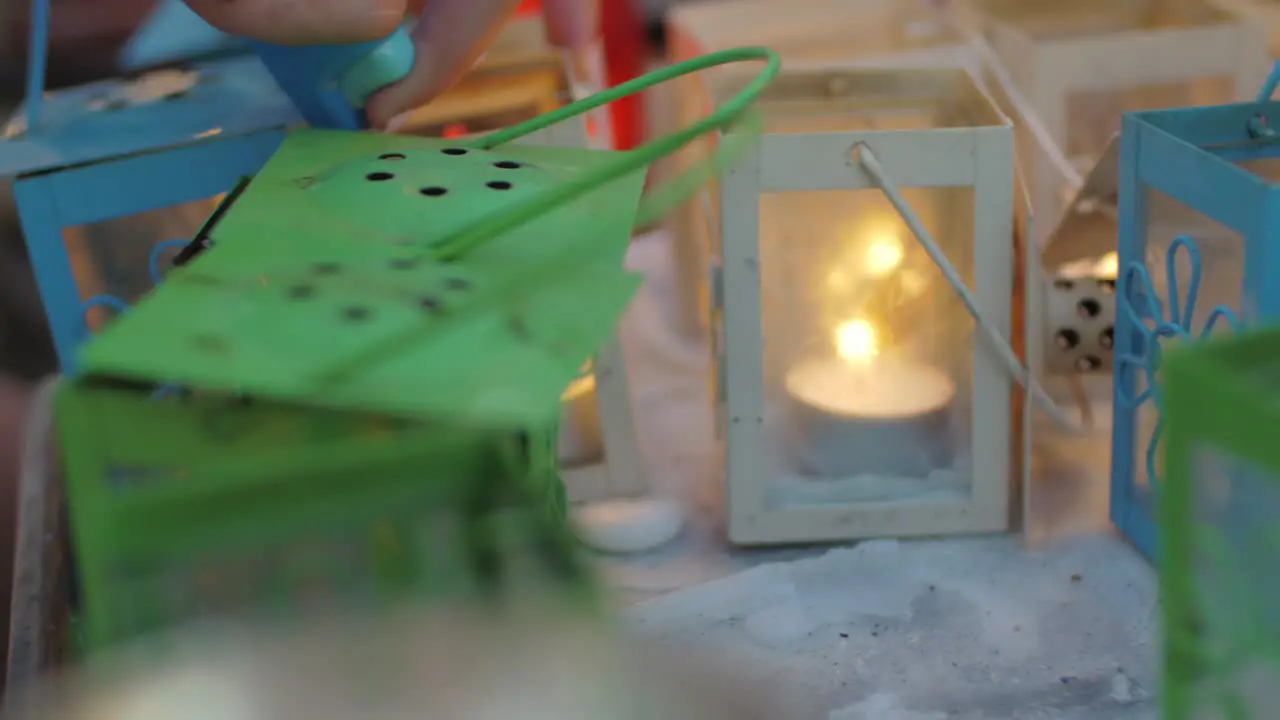 Lighting candles in street lanterns