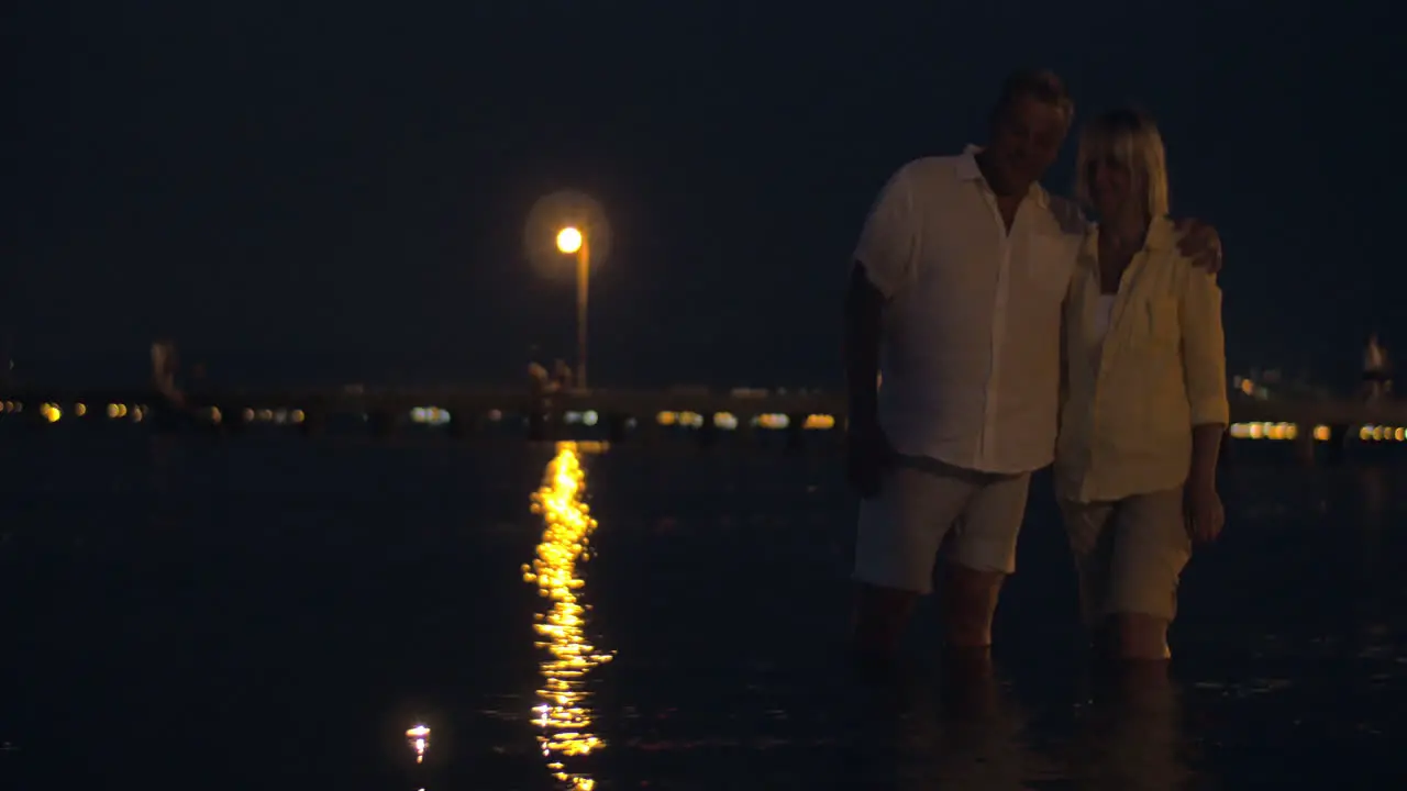 Couple watching candles sailing on water