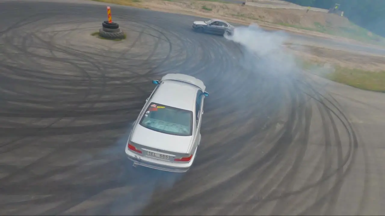 Two BMW cars doing a burnout