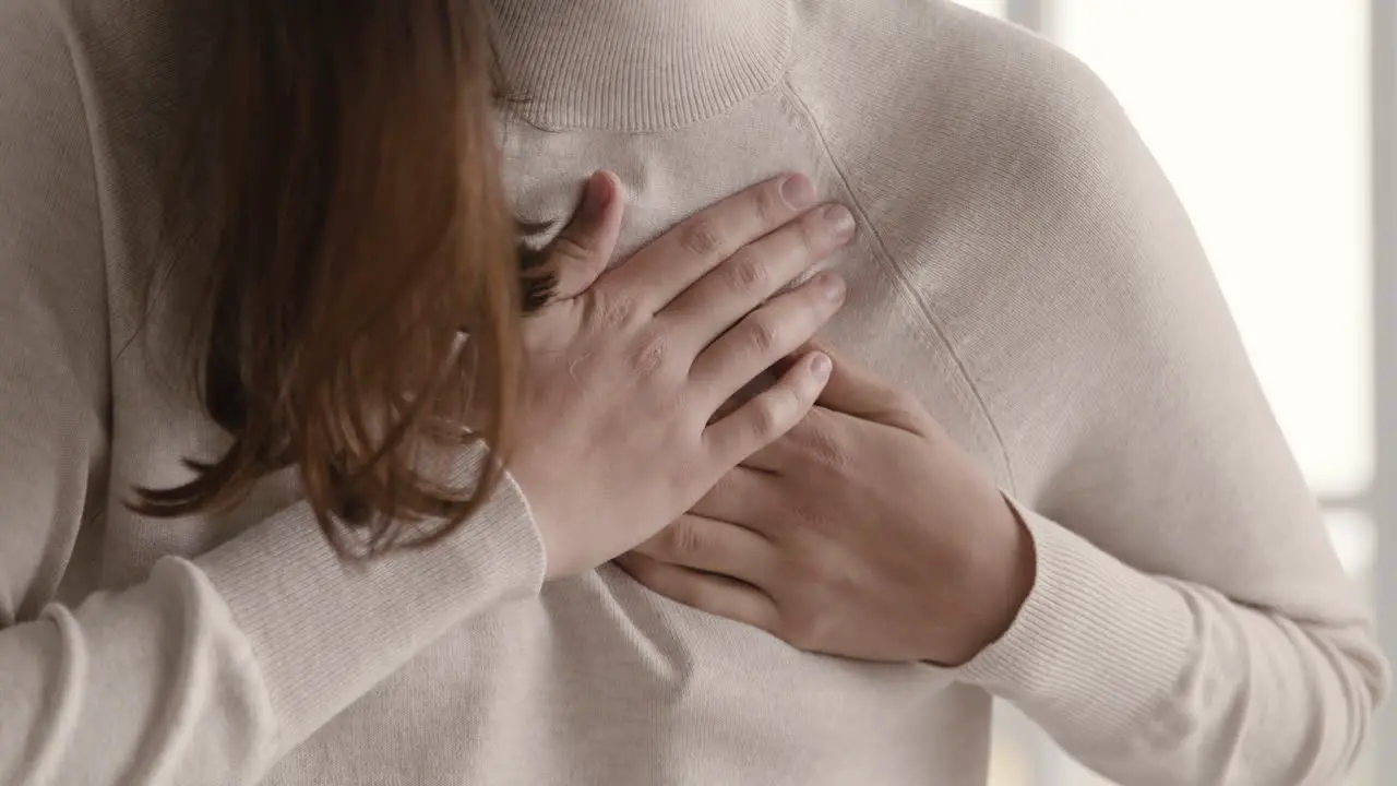 Close Up Of An Unrecognizable Woman Having A Chest Pain And Touching Her Heart Area