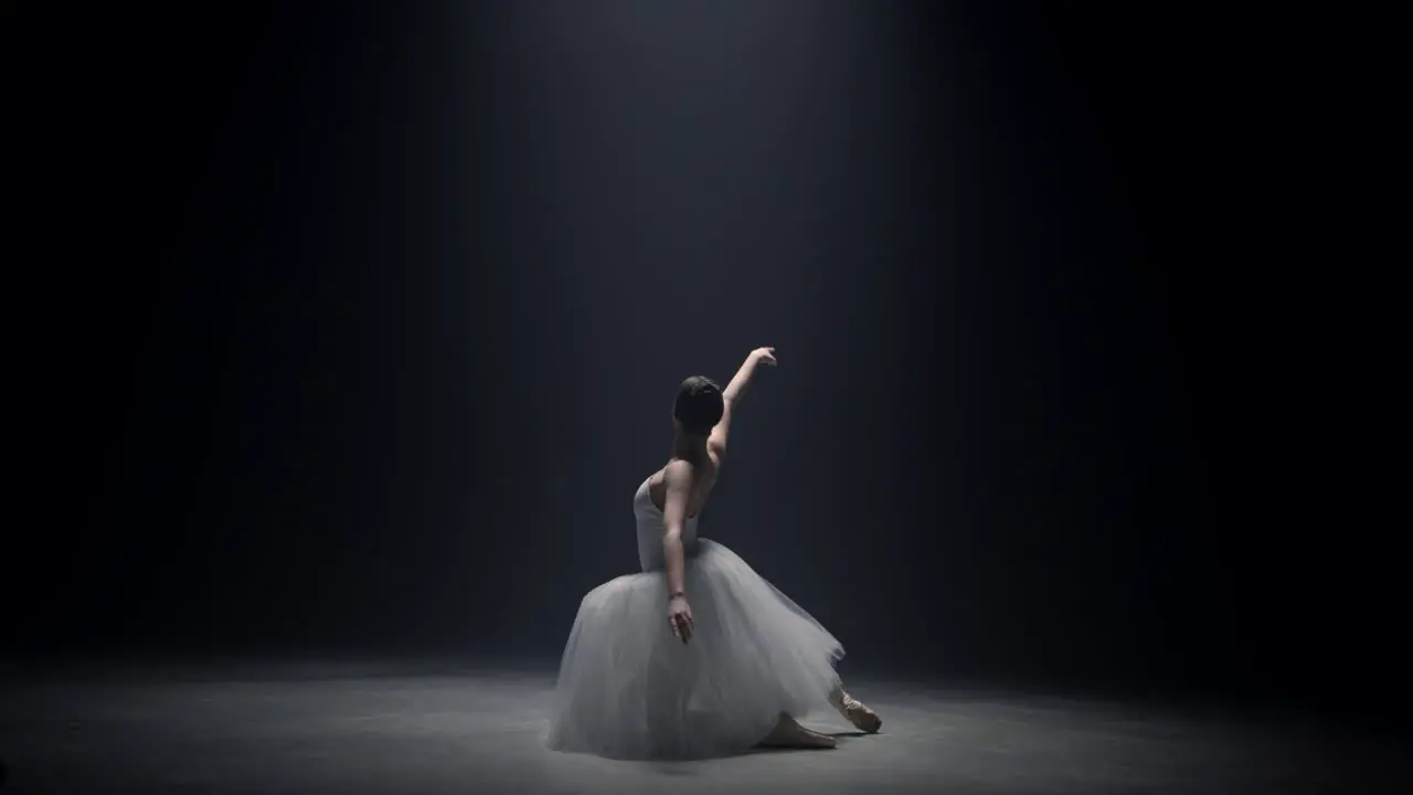 Young ballerina dancing on stage Ballet dancer performing under spotlight