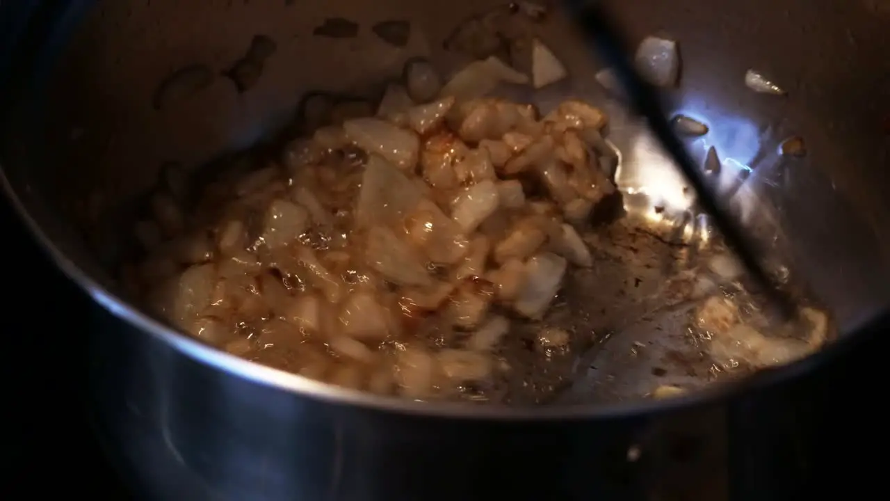 Stirring and browning of diced onions in a stainless pan CLOSE UP