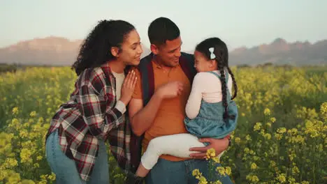 Mom dad and child in field of flowers playing