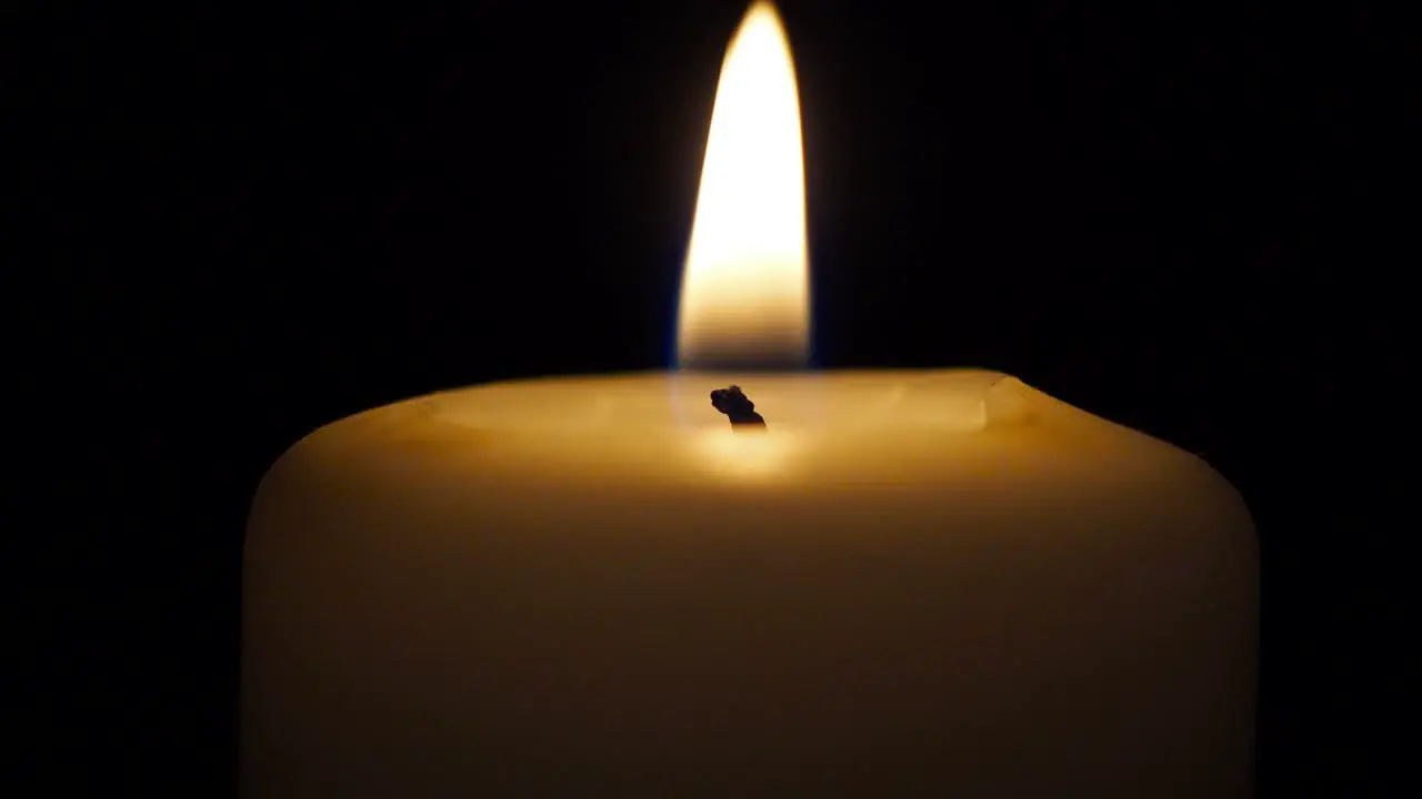 Single candle in dark close up