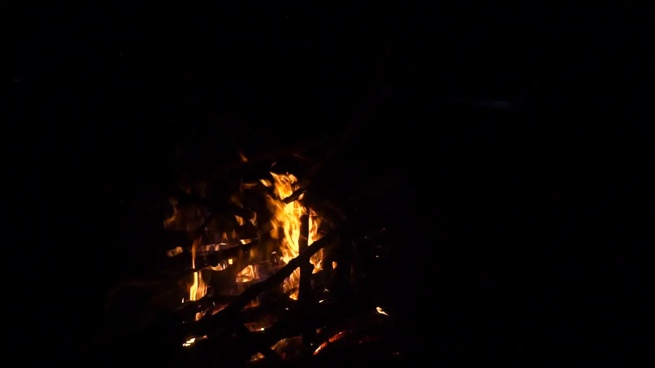 Slow motion shot of burning campfire at night