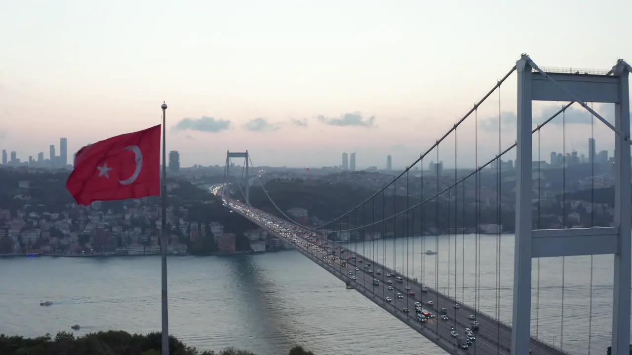 Dolly forward past waving Turkish Flag revealing Bosphorus Bridge Aerial Wide Shot dolly forward