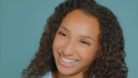 Tracking Shot Approaching Young Adult Woman Smiling Off Camera