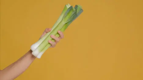 Close Up Shot of Young Adult Woman Holding Leeks