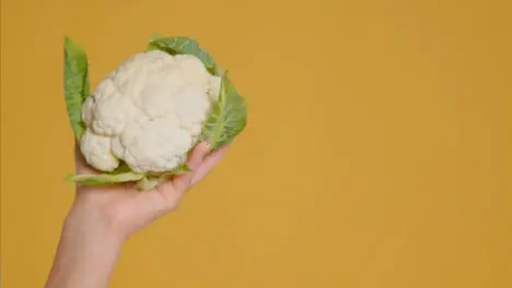 Close Up Shot of Young Adult Woman Holding Cauliflower