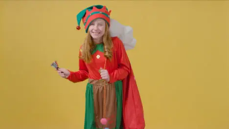 Young Girl Walking Holding Santa Sack and Bell