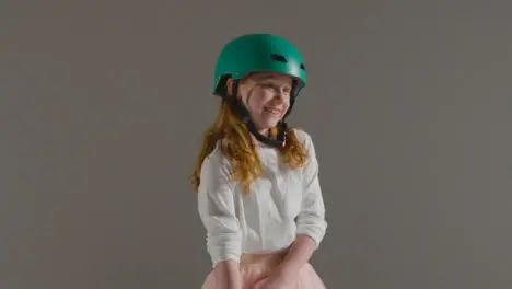 Mid Shot of Little Girl With Skateboard Smiling 