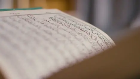 Close Up Of Open Copy Of The Quran On Stand At Home 7