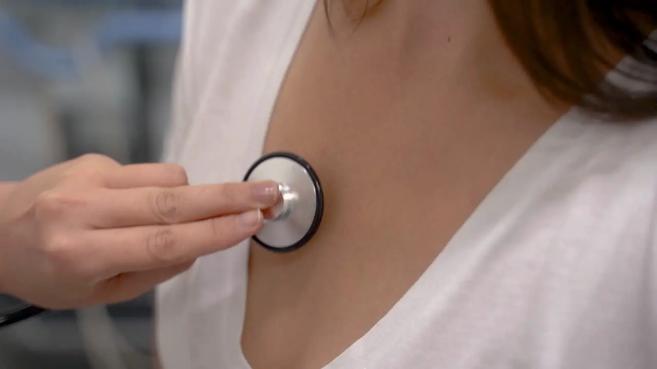 Close Up Of Doctor Hand Using Stethoscope With A Female Patient Checking The Lungs And Heart Beat