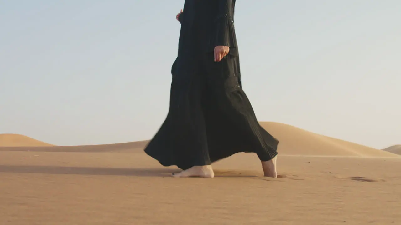 Close Up Of An Unrecognizable Muslim Woman Walking Barefoot In The Desert 2