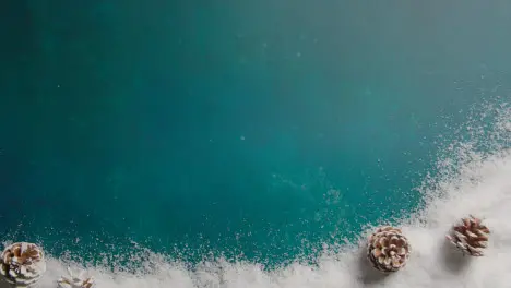 Overhead Christmas Background With Snow And Pine Cones