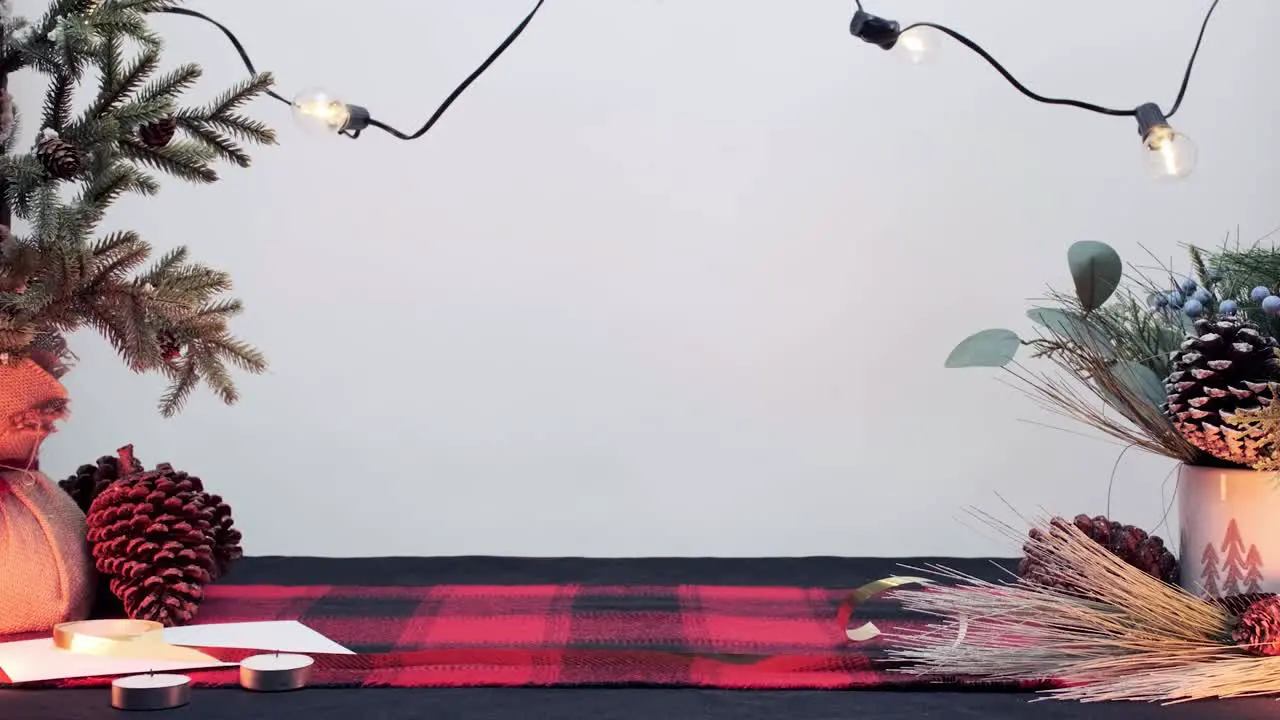 White background with black and red table cloth decorated with holiday elements such as a pine and trees