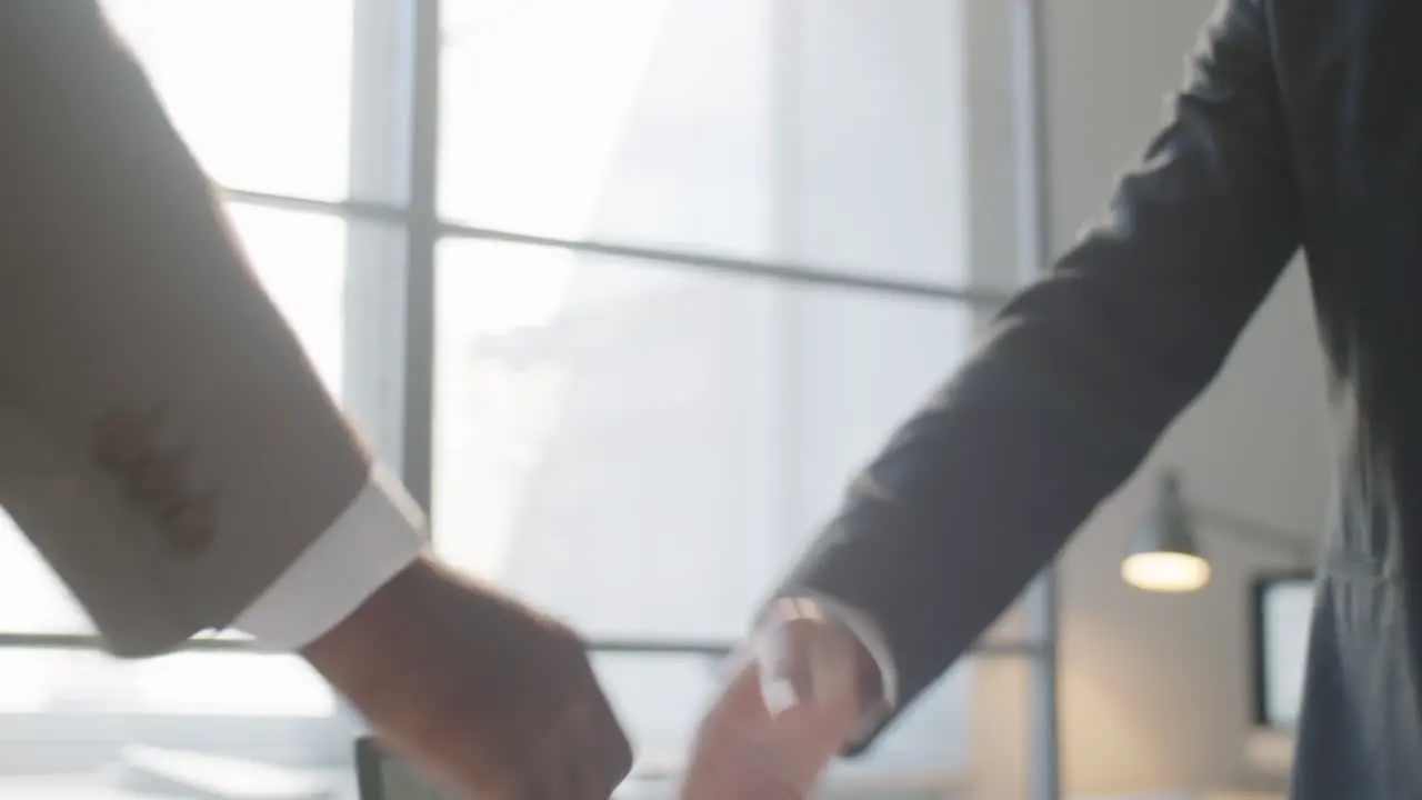 Multiethnic Businessmen Shaking Hands in Office