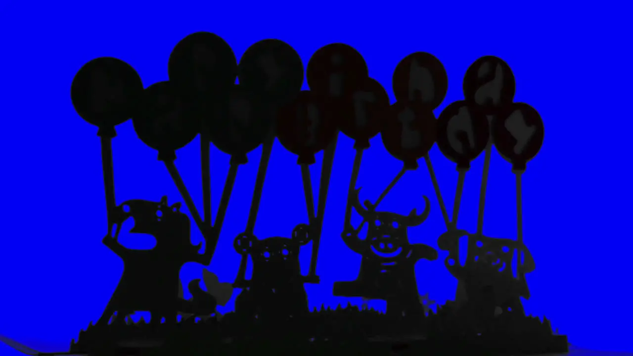 Silhouettes Of Paper Animals With Balloons Fast Rotating On A Blue Background