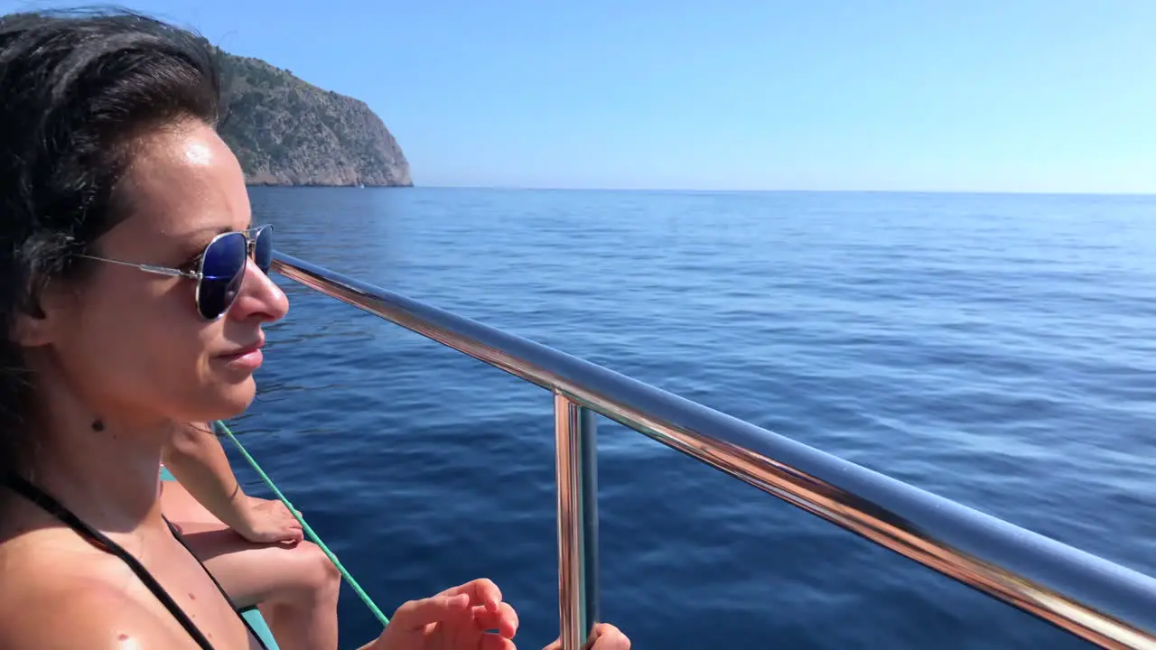 Woman on a boat sailing through the Mediterranean Sea along the coast of Palma de Mallorca