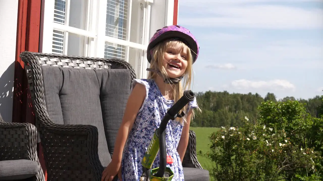 Happy smiling little girl with bike helmet on head