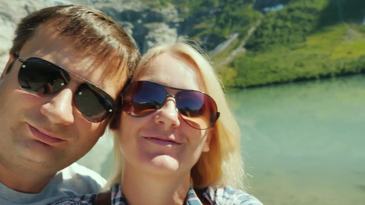 Young Couple Relieves Himself On The Video On The Background Of Mountains And Glacier In Norway Jour