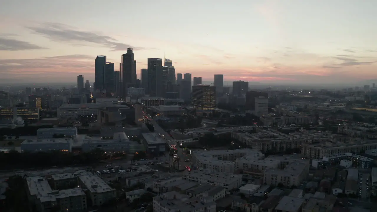 AERIAL Cinematic View of Busy Downtown Los Angeles right after dusk with Skyline City Lights and Car traffic