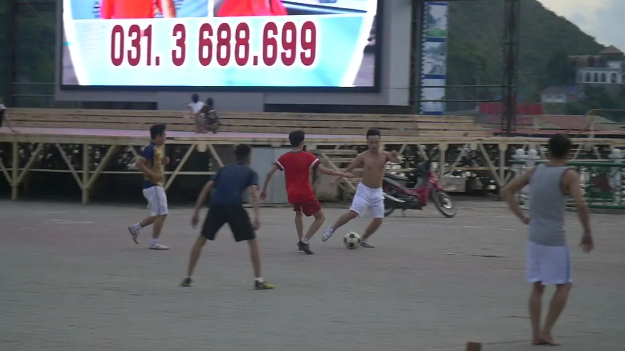 Men Playing Soccer in Street 2