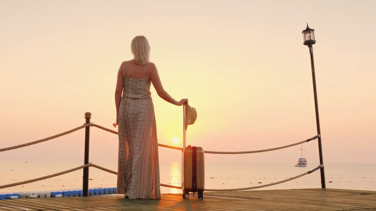 A Lonely Woman Came To A Seaside Resort Standing On A Pier Staring Into The Distance On The Sea Surf