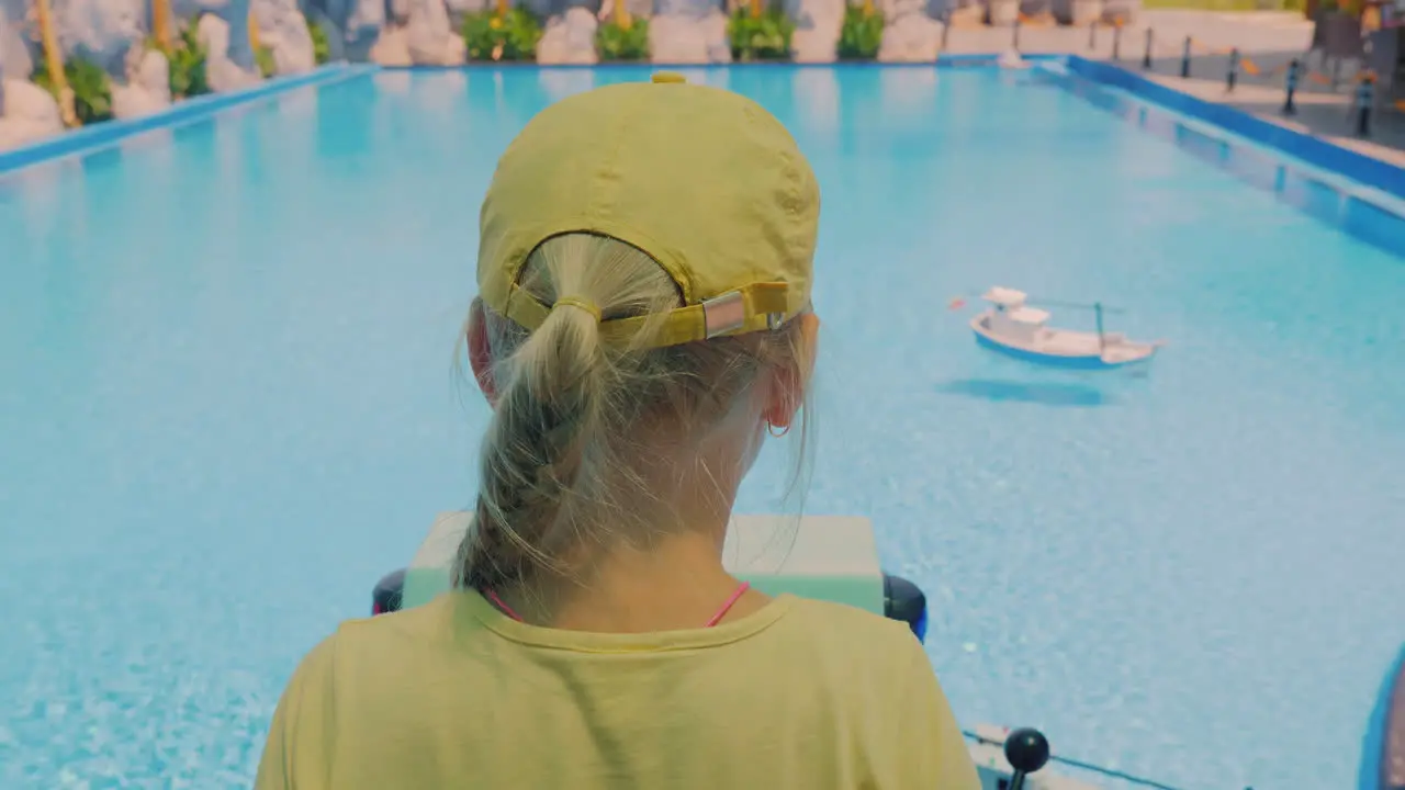 Girl Playing On A Toy Boat Ride Control Which Float In The Pool 4k Video