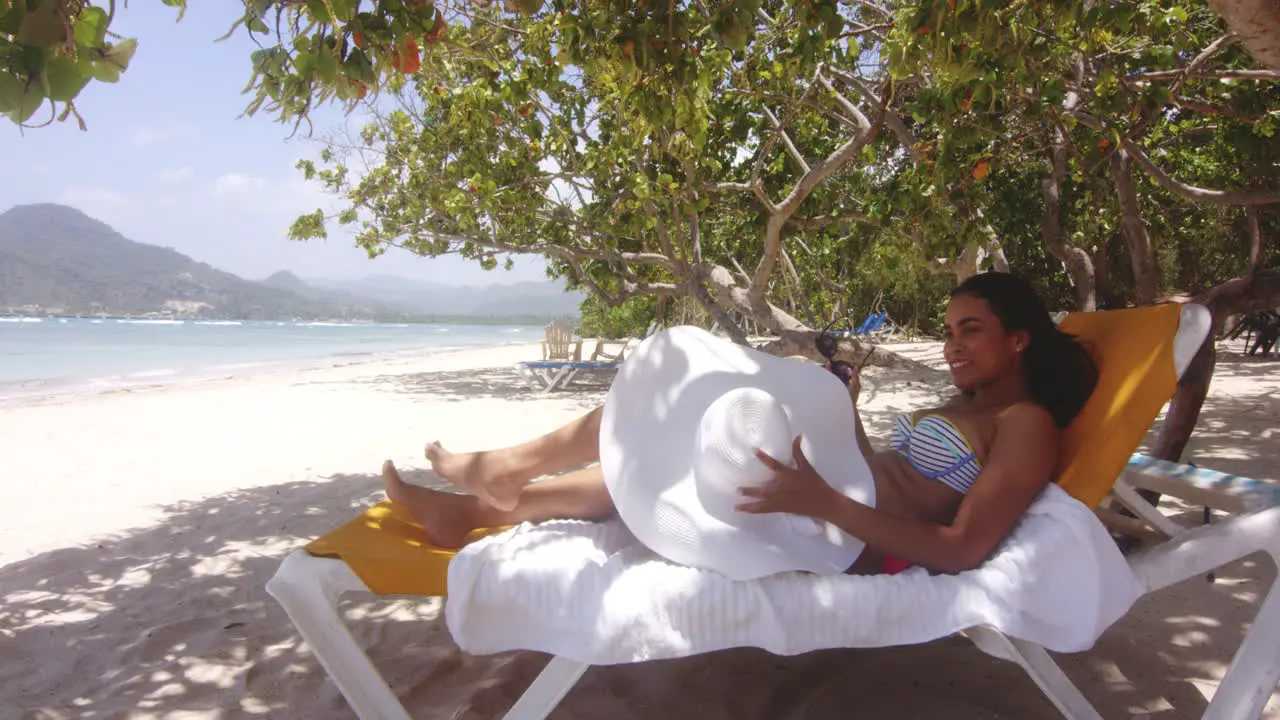 Latino Dominican Lady Gets Up from Sun Lounger on Tropical Beach Resort Playa Teco Maimon