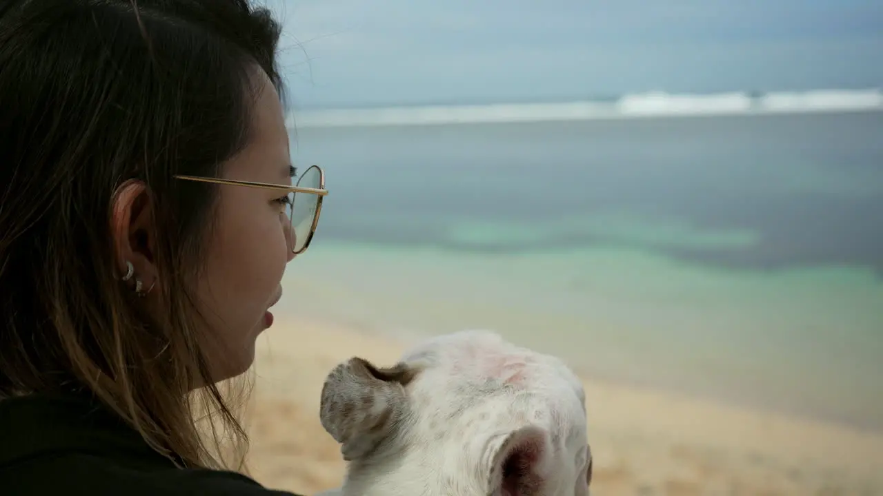 Close -up Shot Of A Woman Hugging And Kissing A French Bulldog