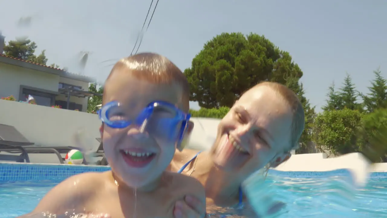 Mother and bathing in pool at the villa