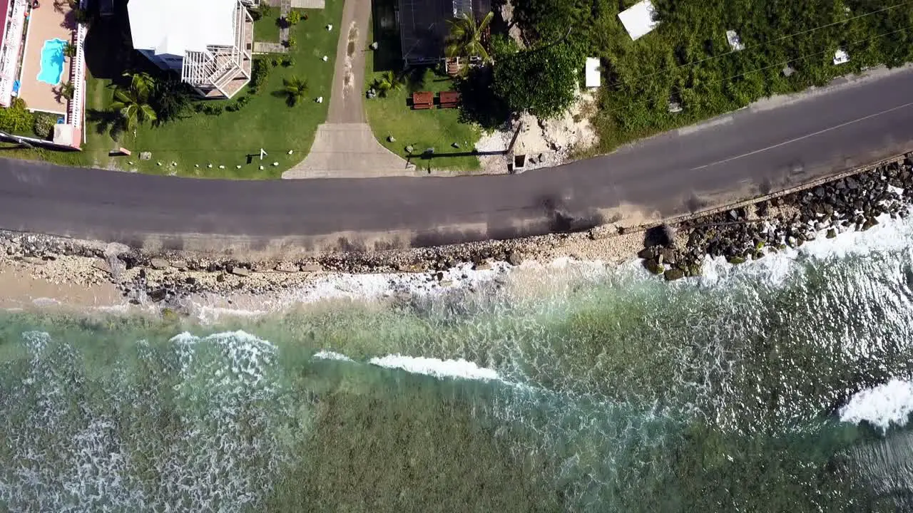 Aerial straight down angle fly over beach and a local home on BVI island Tortola