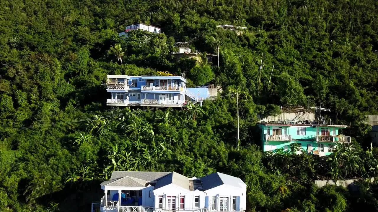 Aerial crane shot of local homes on a hillside on BVI island Tortola