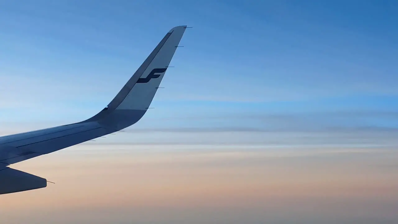 Finnair airplane wing in the air with beautiful background sky