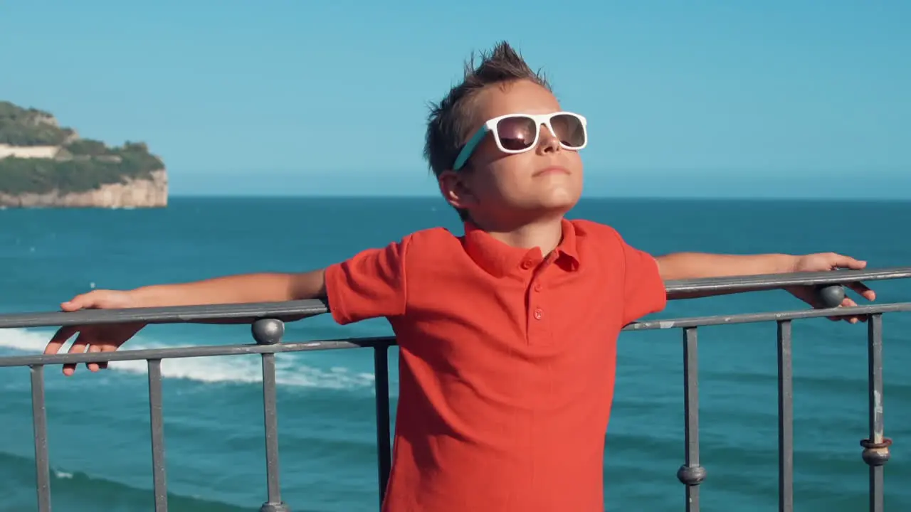 Joyful boy relaxing outdoor Cheerful guy enjoying summer vacation at coastline