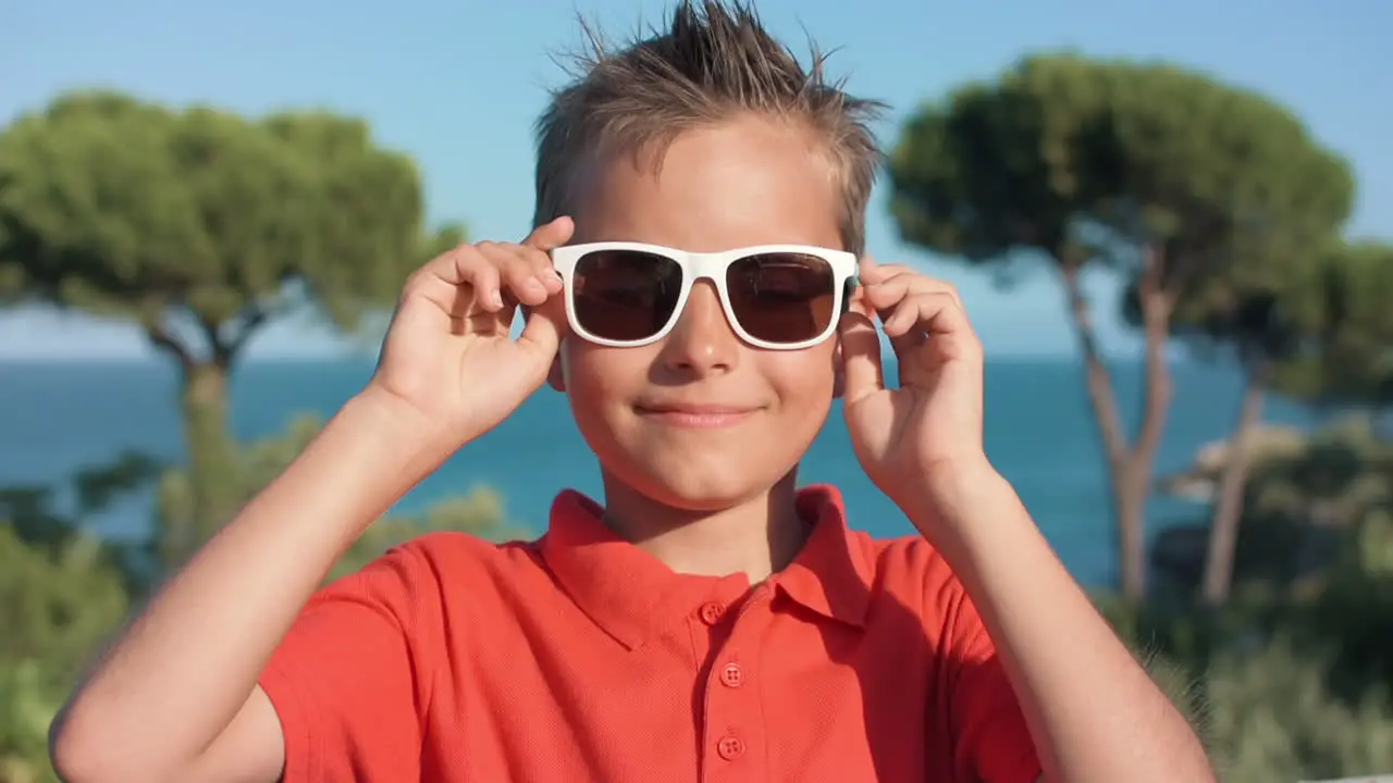 Smiling guy enjoying summer vacation outdoor Boy relaxing at seaside