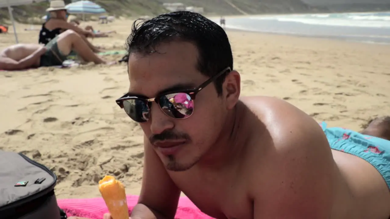 Hispanic Male Eating an Ice Cream Cone at the Beach