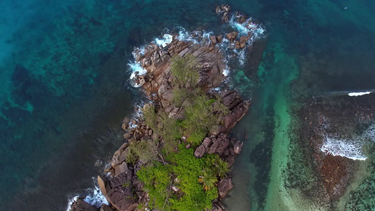 Drone shot over granites rocks near the shore of Port glaud Mahe Seychelles