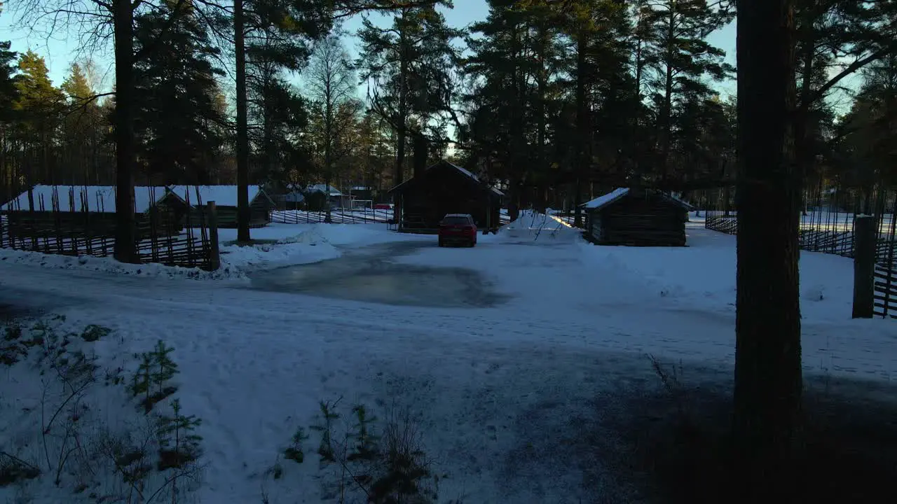 Reveal Vacation Log Cabins in Snow in Rural Forest Aerial Rising