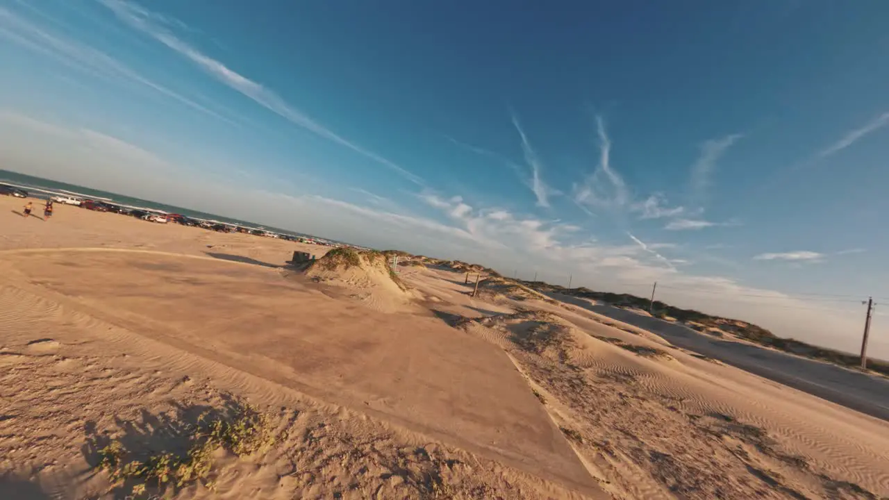 FPV Aerial drone flyover of sand dunes on South Padres Island Texas beach at Sunset