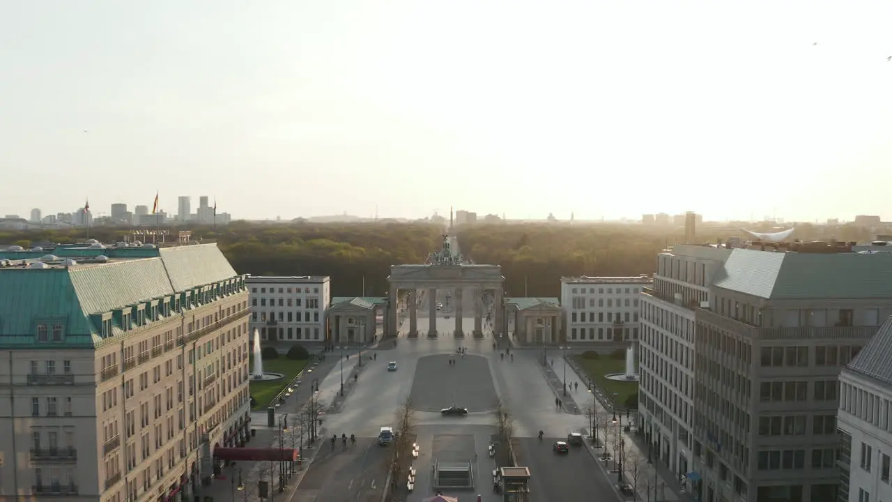 AERIAL Brandenburger Tor with almost no People in Berlin Germany due to Coronavirus COVID 19 Pandemic in Beautiful Sunset Light