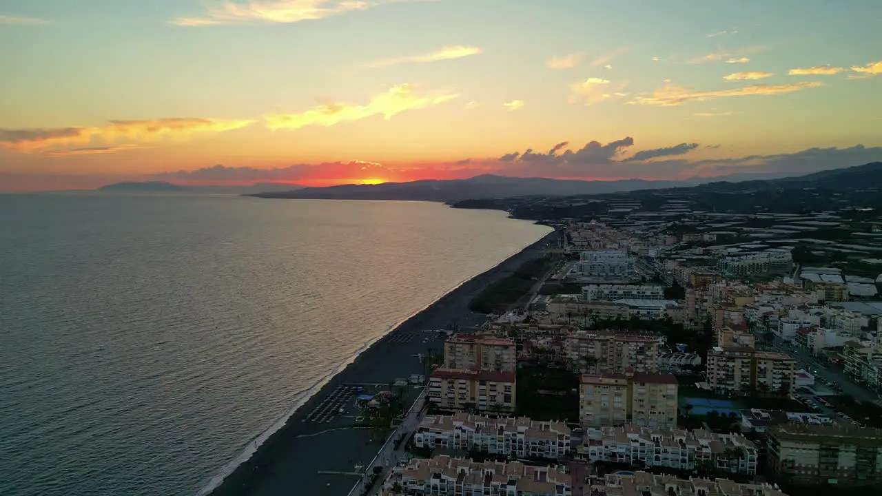 sSunset Elevation Malaga Coastal Hotels and Distant Yellow Sky Captured by Drone