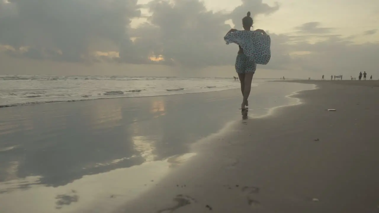 An Indian woman's legs as she strolls along the beach