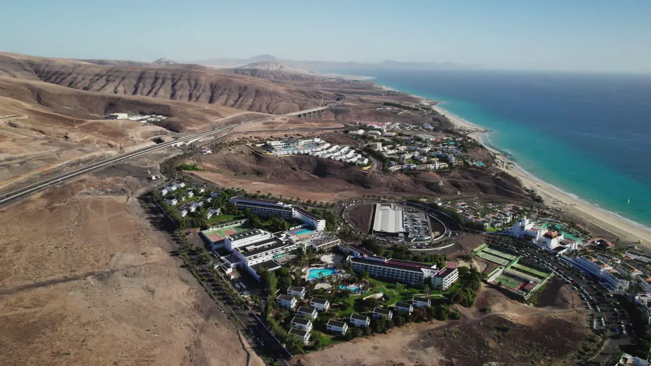 Coastal resorts in Fuerteventura contrasting with arid landscapes aerial shot