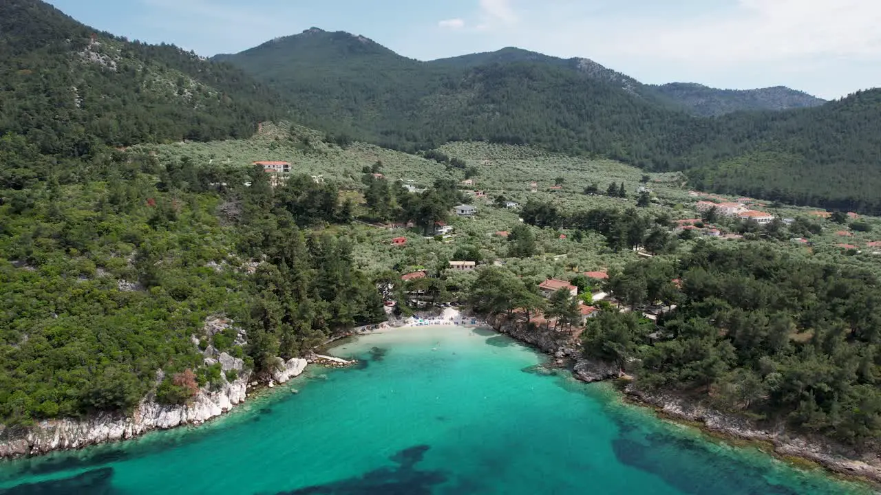 Rotating Drone View Of Glifoneri Beach With Crystal Clear Water And Surrounded By Lush Green Vegetation Thassos Island Greece Europe