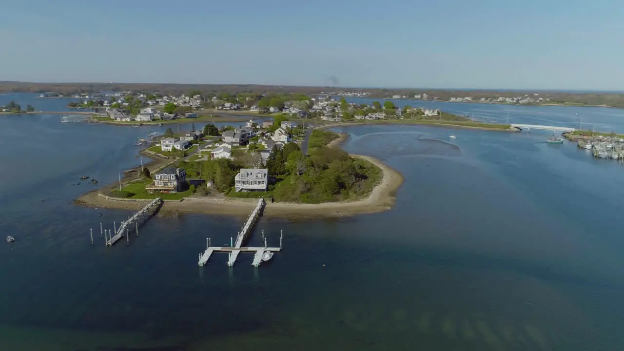 Aerial of a tropical island with beach houses that have boat docks in the summer time