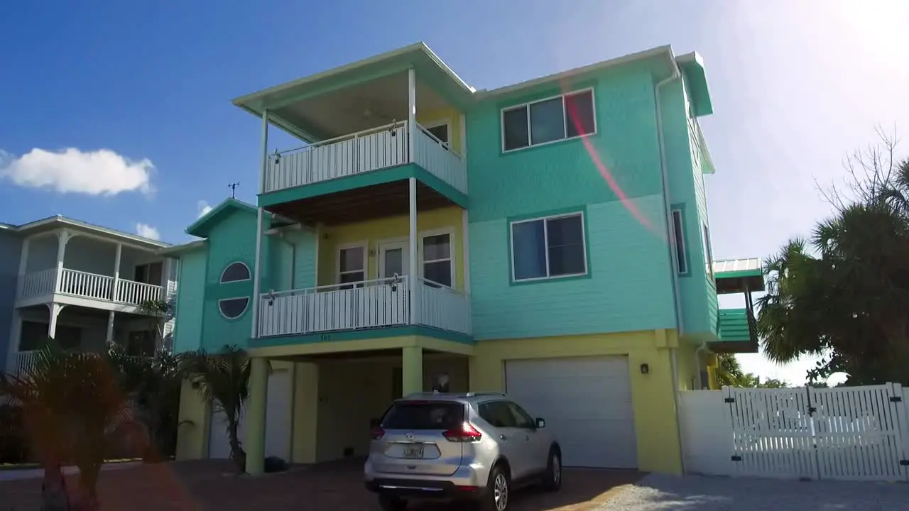 A slow moving shot passing several colorful vacation homes on Anna Maria Island Florida