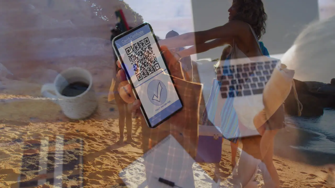 Animation of woman with covid passport on smartphone over diverse friends on beach